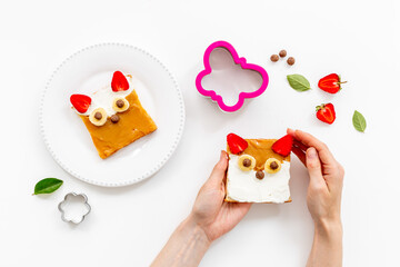 Fox faces sandwiches for funny kids breakfast. Sandwich made from peanut butter and strawberries