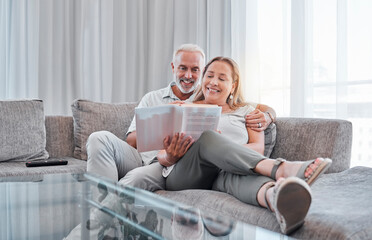 Senior couple reading book on sofa together enjoying weekend, freedom and retirement at home. Love, relaxation and mature man and woman read novel bonding, smiling and sitting on couch in living room