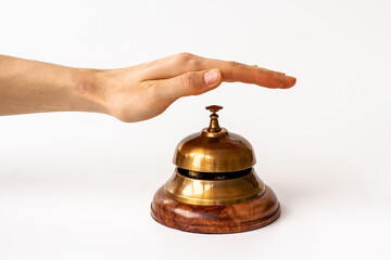 Fototapeta na wymiar Hand on metal golden service bell. Attention concept