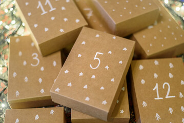 Paper handmade boxes to Christmas Advent Calendar with day numbers and drawn pattern - obrazy, fototapety, plakaty