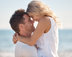 Fototapeta premium Beach, love and couple nose touch with smile for romance, bond and happiness with carrying hug. Partner, holiday and Canada ocean embrace in summer for happy, relaxing and intimate memory.