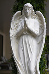White statue of an angel praying