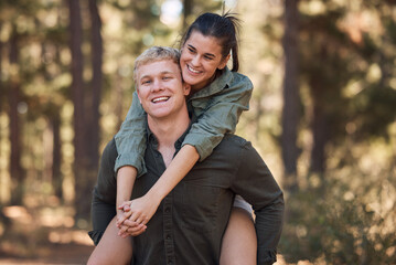 Couple, hug and smile for piggyback in nature walk, love and support for fun relationship bonding...