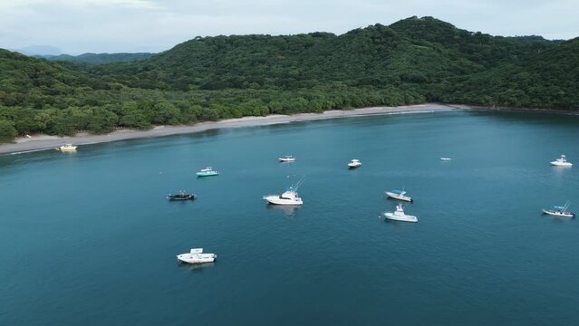 Aerial view of scattered white boats near the beach of El Jobo in Guanacaste, Costa Rica