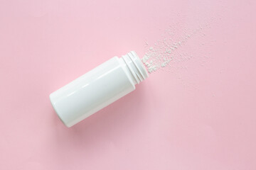 Spilled baby talcum powder in container. Kids skin care cosmetic