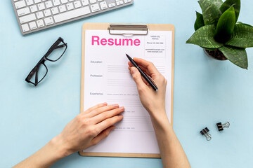 Employer reviews resume application form on office table