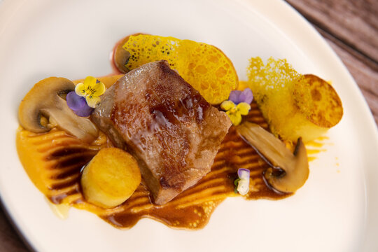 Recipe for veal, potato confit, mushroom, carrot puree, balsamic vinegar sauce, honey and veal stock. High quality photo