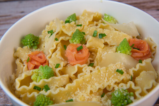 Homemade pasta with smoked salmon, broccoli, parmesan and lemon, healthy food. High quality photo