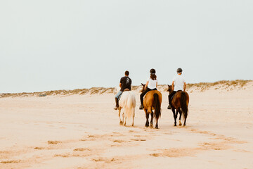 Horseback riding on Supertubos beach at the end of the day, with little fog, in Atouguia da Baleia and close to Peniche, in the western region of Central Portugal.