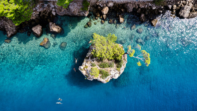 Beautiful Punta Rata beach in Brela, Croatia, aerial view. Adriatic Sea with amazing turquoise clean water and white sand on the beach.