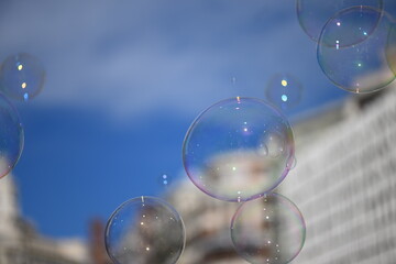 Shiny soap bubbles in front of a blurred building in the inner city of Valencia-Spain.