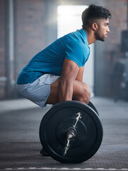 Fototapeta na wymiar Fitness, deadlift and man in gym in a workout, exercise or strength training for strong powerful legs and core. Focus, wellness and healthy Indian sports bodybuilder weightlifting a heavy barbell