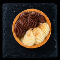 Fresh dessert tartlet with white and milk chocolate.