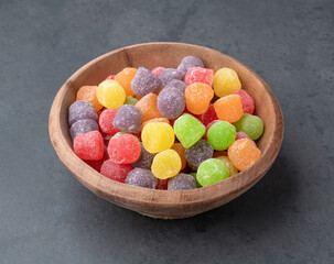 Colorful gum drop candies over stone background