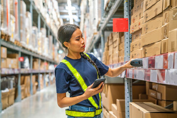 Asian female employees wear reflective safety uniforms, arrange items on shelves and control the quality of wrapping products before delivering to customers in warehouses and wholesale stores. - obrazy, fototapety, plakaty
