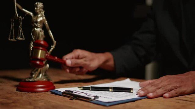 Footage of close of hands of lawyer and client are discuss and signing on indictment, plaint or appeal.