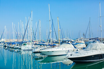 White luxury yachts on the pier. Sea trip, yacht rental, sea excursions. Ships on the coast moored to the shore.