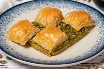 Pistachio baklava on a white wooden background. Turkish cuisine delicacies. Turkish baklava. close up