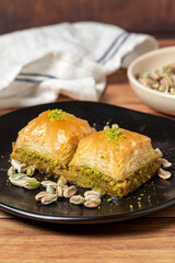Pistachio baklava on wooden background. Turkish cuisine delicacies. Turkish baklava. close up