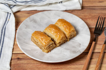 Walnut baklava on wooden background. Turkish cuisine delicacies. Turkish baklava. close up