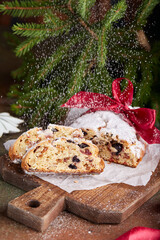 Stollen Christmas cake with nuts, spices, dried and candied fruit, coated with powdered sugar. Delicious traditional German homemade dessert. Fruit bread.