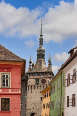 Fototapeta premium Vertical photo of 64 meters high Clock Tower of Sighisoara (Turnul cu Ceas) is the main entry point to the citadel, purpose was to defend the main gate of the citadel, Transylvania, Romania