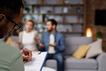 A visit to a family psychologist for a married couple. An African-American psychologist doctor...
