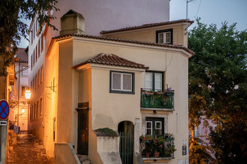 Houses in the famous Alfama district of Lisbon with steep streets and vintage lighting