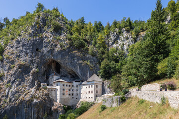 Fototapeta na wymiar Impregnable medieval marvel of Predjama Castle (Predjamski grad) has been perched in the middle of 123-metre-high cliff, and is largest cave castle in world, Postojna, Slovenia 