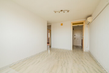 Residential house with light vintage stoneware floors, access to several rooms and wall lights on...
