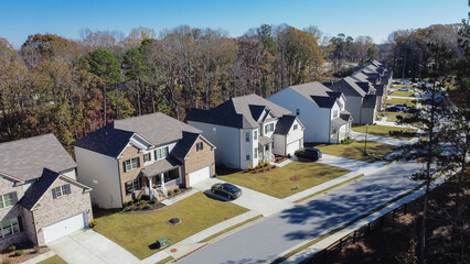 Close-up aerial view new development two story houses with two car garage drive way in Flowery...
