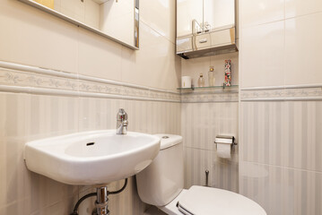 Small bathroom with porcelain sink, valanced tile, and subtly grated tile