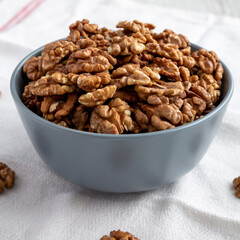 Raw Organic Walnuts in a Bowl, side view.