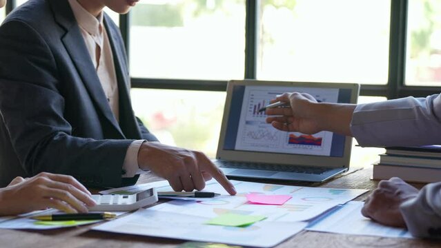 Financial analyst analysis business financial report on digital tablet during discussion at meeting of corporate showing the results of their successful teamwork., business meeting concept, Marketing	