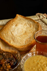 Sri Lankan flat bread with Sri Lankan style dhal curry, chicken curry with famous Sri Lankan tea. Delicious Sri Lankan cuisine. 