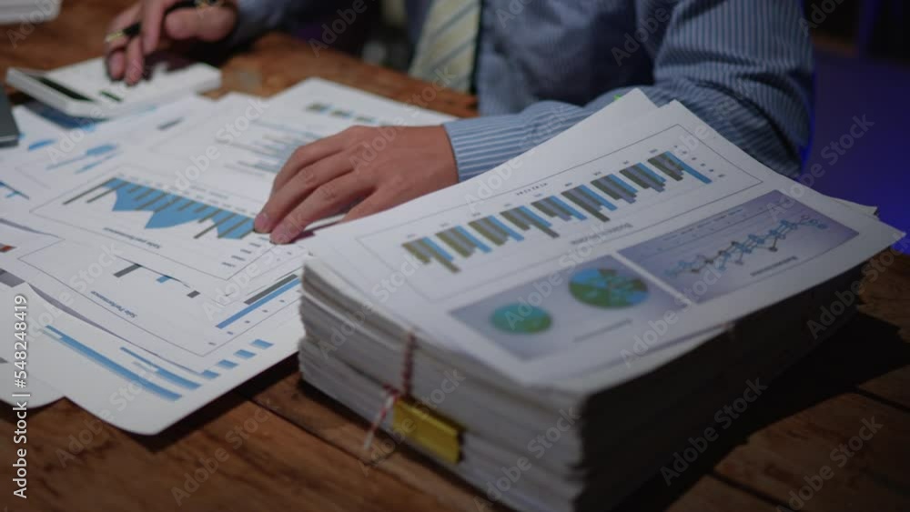 Poster close up of business hands working overtime night shift and calculating on financial and accounting 