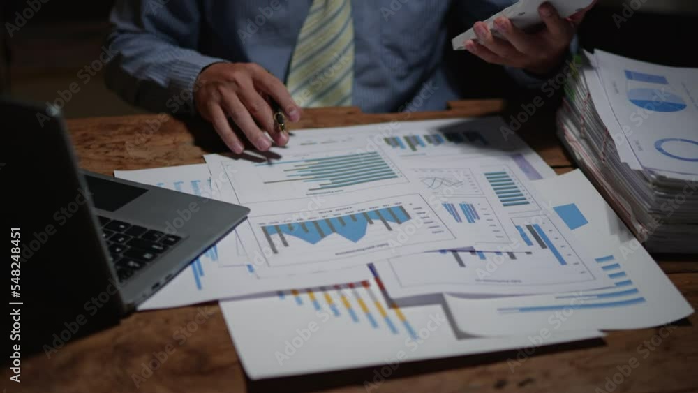 Poster close up of business hands working overtime night shift and calculating on financial and accounting 