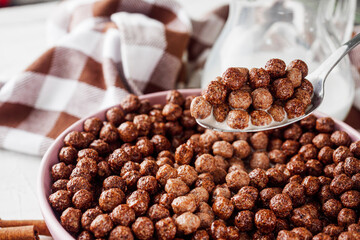 sweet crunchy chocolate children's breakfast chocolate balls on a white background