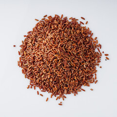 raw fresh red rice on a white background