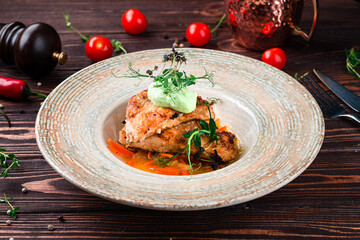 Fried chicken pieces with sweet peppers, onions, herbs and sauce.