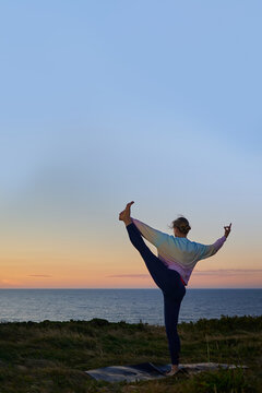 healthy woman in yoga class doing exercise outdoor. vertical image with big copy space