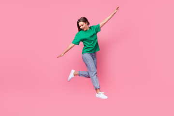 Full size portrait of cheerful energetic girl jumping flight arms wings isolated on pink color...