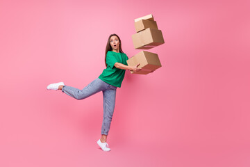 Full size photo of impressed gorgeous clumsy girl dressed green t-shirt jeans falling with boxes...