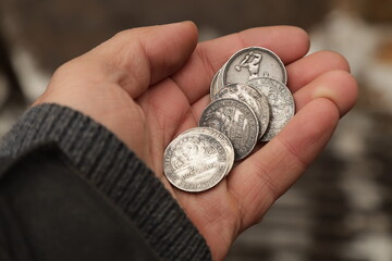 Old silver soviet coins in hand