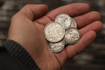 Old silver soviet coins in hand
