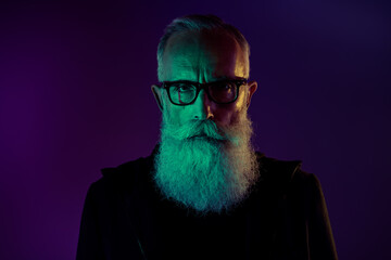 Photo of dangerous serious retired man dressed black pullover eyewear isolated dark green purple color background