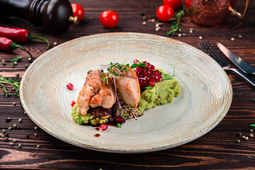 Dieting food turkey fillet with lentil puree with pomegranate sauce and microgreens.