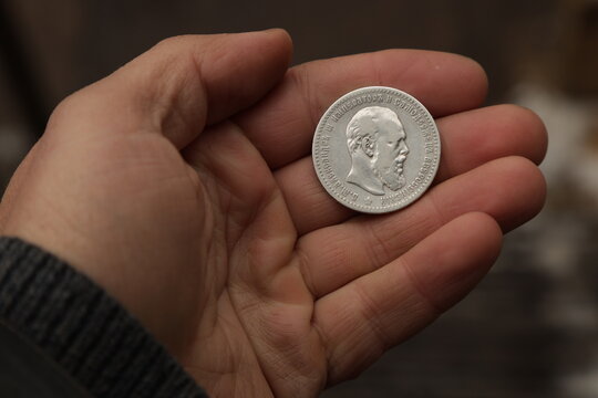 Silver coin of Russian Empire one ruble in hand