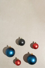 Christmas decoration baubles on grey stone background. Minimal New Year concept.