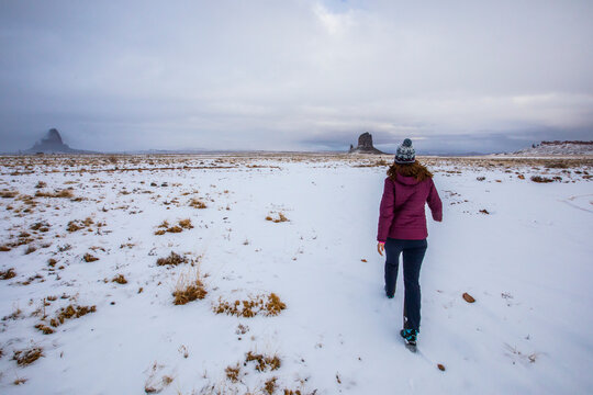 Girl walking in winter in Monument Valley. Utah, United States Of America